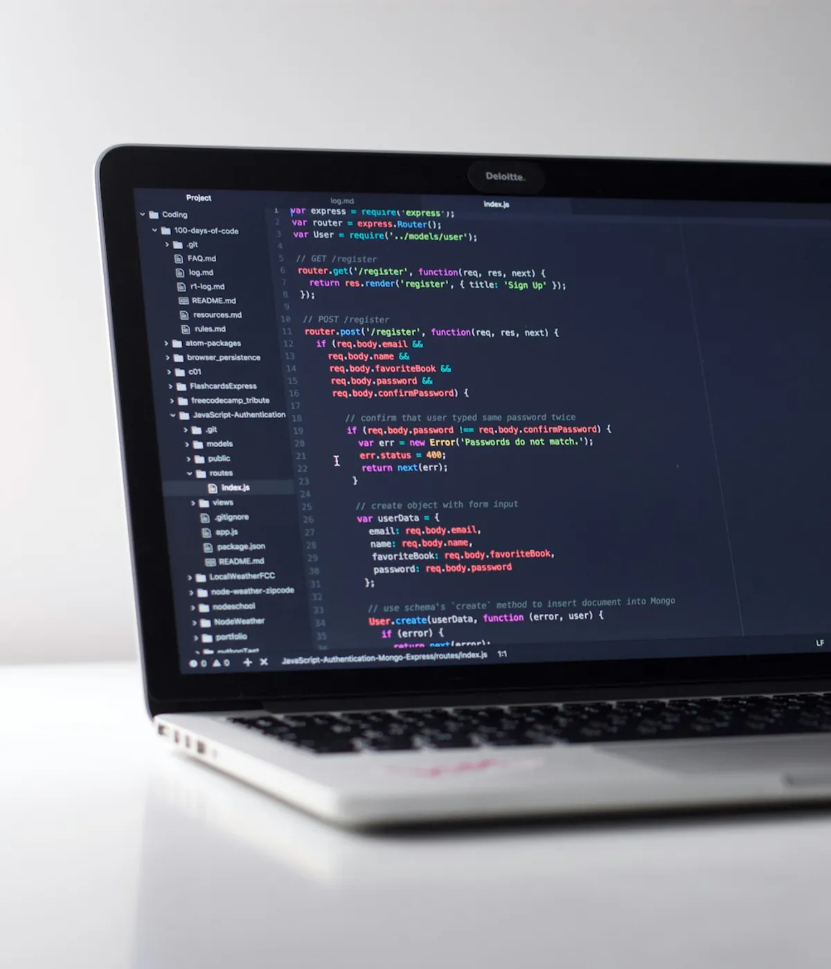 Developer working on a modern storefront interface with code open on a laptop