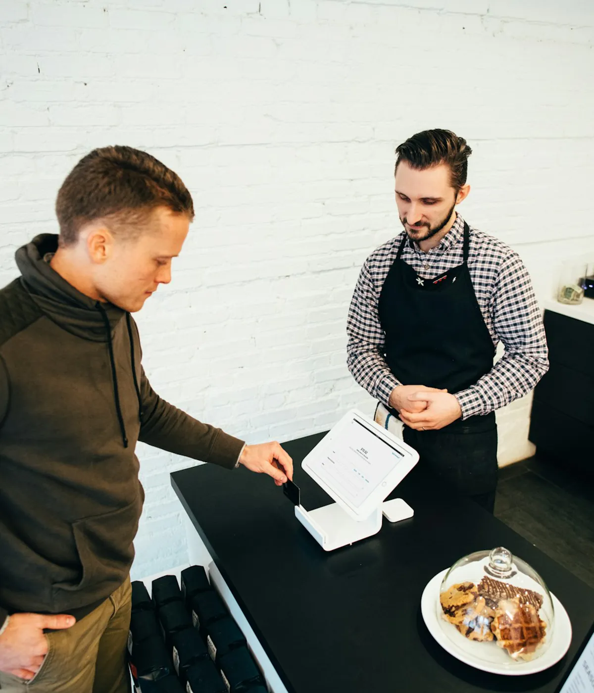 Retail staff member using a tablet to find and organize products